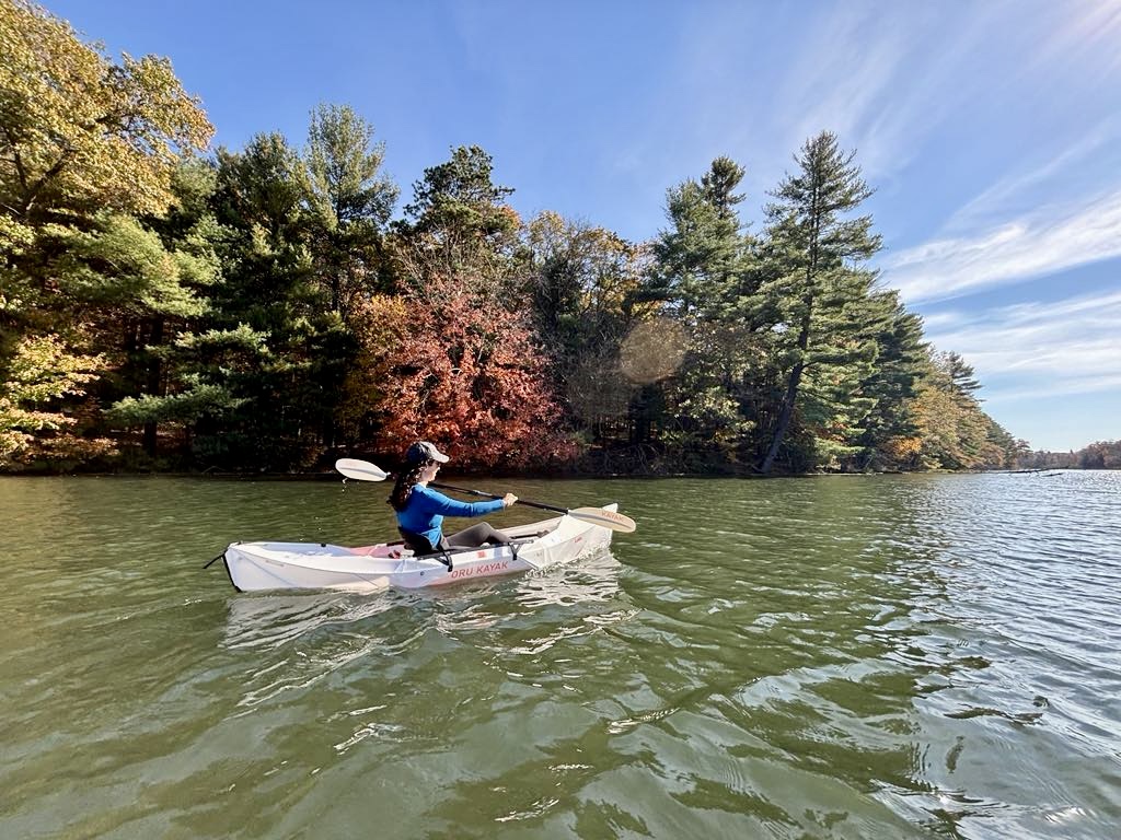 Cassandra kayaking on a lake as part of nature-informed therapy